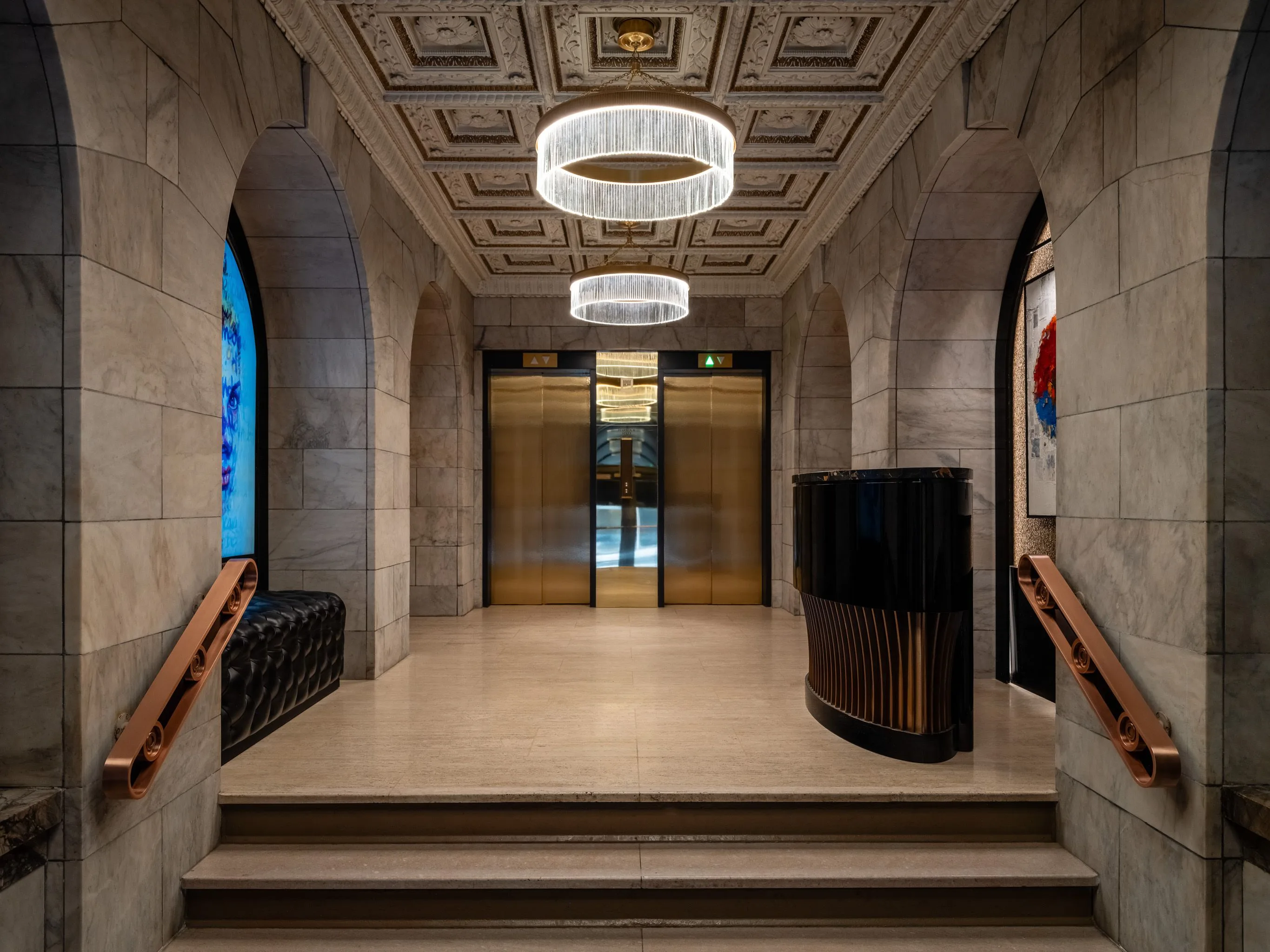 The Chapman lobby at Harbour Sixty — coffered ceiling, marble arches, brass elevators